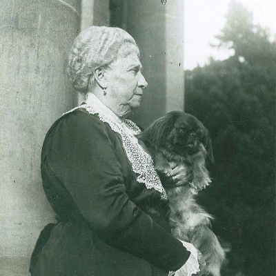 Mrs Ropner holding her dog small dog on her lap in 1882.