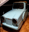 Light blue 3 wheeled car inside the museum