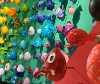 Collection of many different decorated and coloured eggs displayed on a wall.