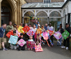 Group of people holding kites made from the Fly With Me event.