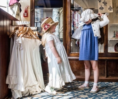 two girls trying on Victorian clothing