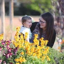 Mother and child walking amongst the flower beds in the Walled Garden