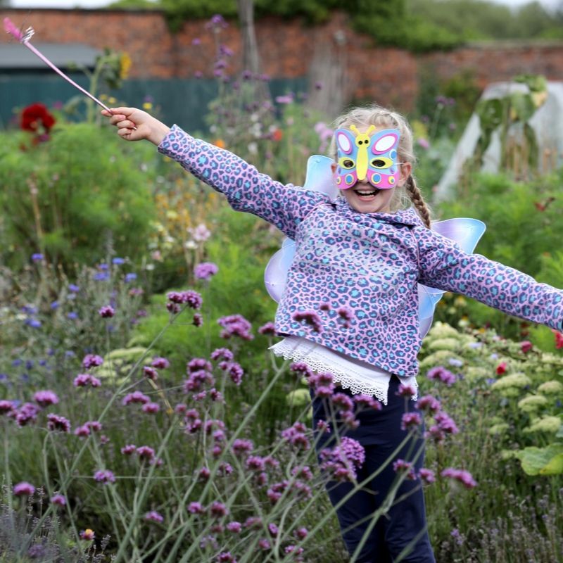 Girl Dressed As A Butterfly in the Walled Garden