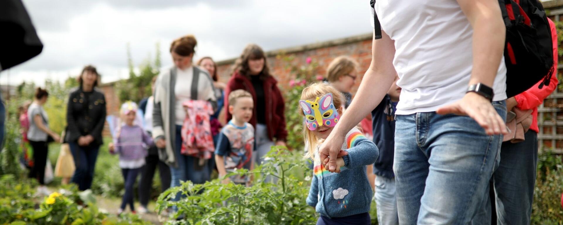 Family Exploring The Walled Garden Dressed As Butterflies At Togetherfest 2019