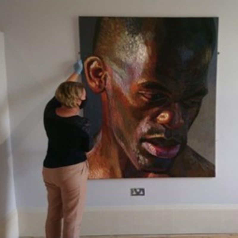 Hanging 'Giant Head of Ben' portrait for an exhibition