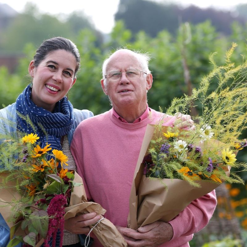 Couple With Fresh Cut Flowers In The Walled Gaden