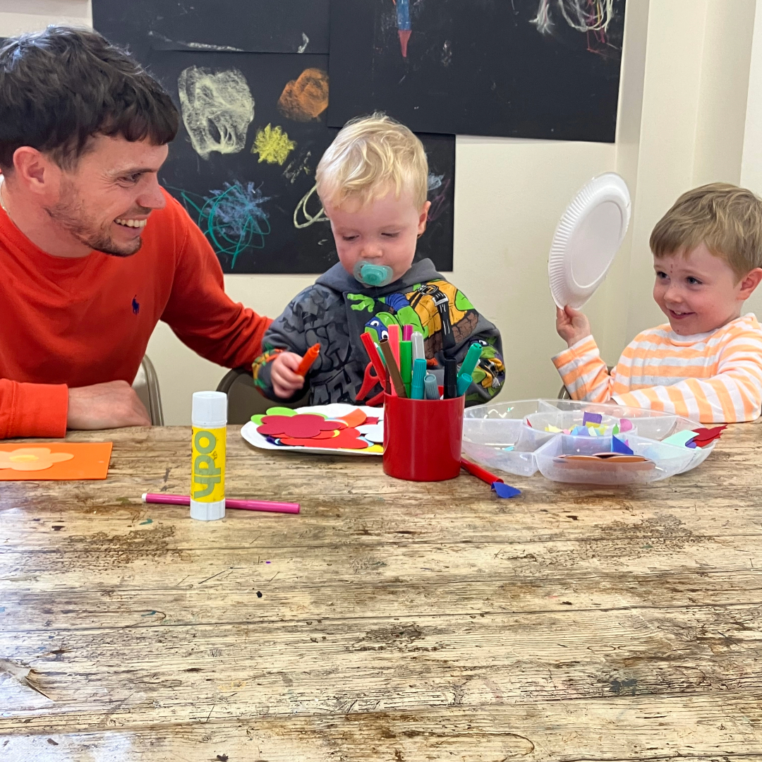Dad and boys in learning room crafting